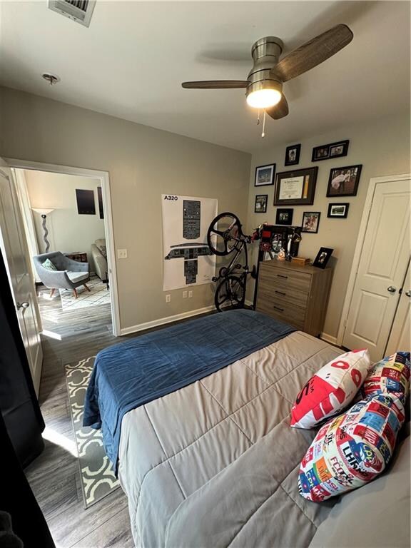 bedroom featuring ceiling fan and wood-type flooring