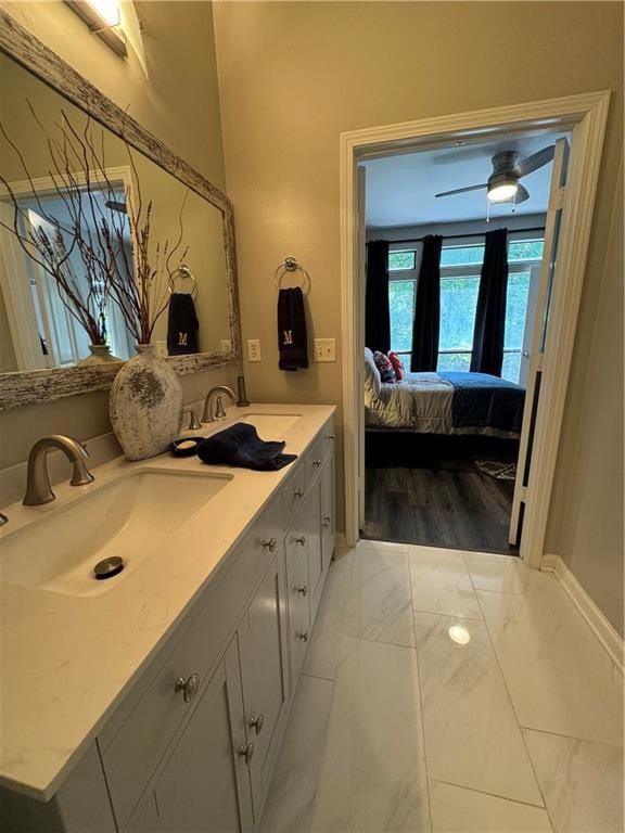 bathroom with ceiling fan, dual vanity, and hardwood / wood-style flooring