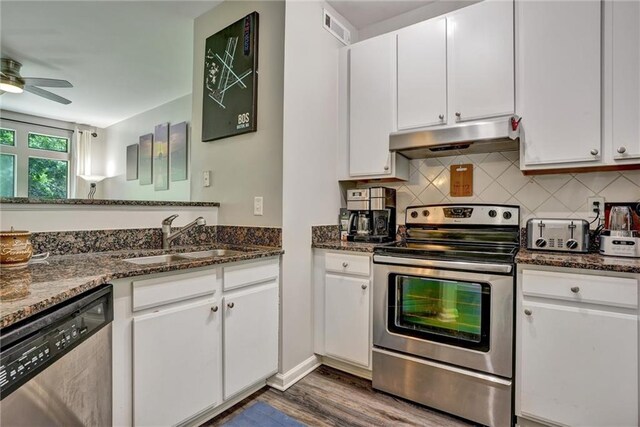 kitchen with ceiling fan, sink, white cabinets, stainless steel appliances, and dark hardwood / wood-style flooring