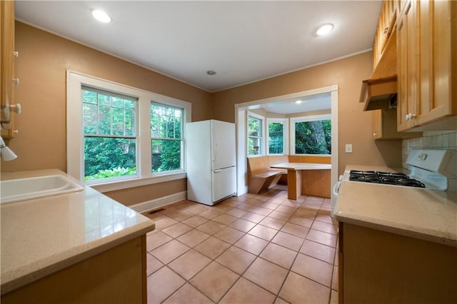 1276 Lanier Blvd NE, Atlanta, GA 30306 - kitchen with white appliances, healthy amount of natural light, light tile patterned flooring, recessed lighting, and baseboards
