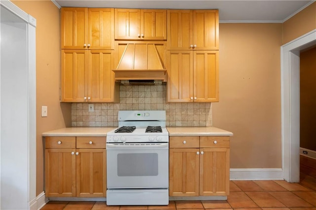 1276 Lanier Blvd NE, Atlanta, GA 30306 - kitchen with white gas stove, custom range hood, decorative backsplash, baseboards, and light countertops