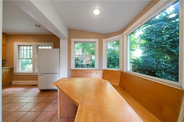1276 Lanier Blvd NE, Atlanta, GA 30306 - unfurnished dining area featuring healthy amount of natural light, light tile patterned flooring, and lofted ceiling