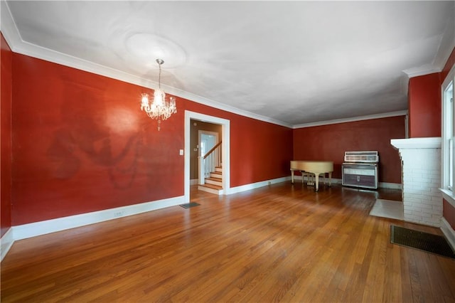 1276 Lanier Blvd NE, Atlanta, GA 30306 - unfurnished living room with hardwood / wood-style floors, a chandelier, stairway, baseboards, and crown molding