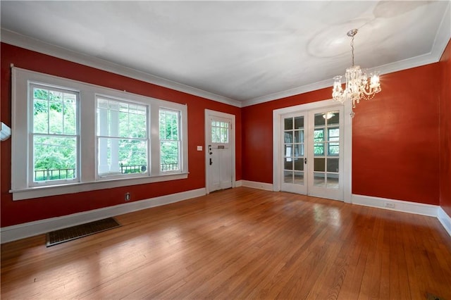 1276 Lanier Blvd NE, Atlanta, GA 30306 - entrance foyer with a chandelier, healthy amount of natural light, wood finished floors, baseboards, and crown molding