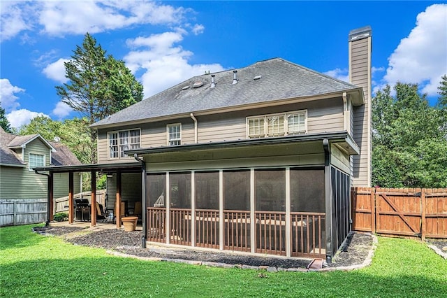 3117 Blowing Wind Ct NW, Acworth, GA 30101 - back of house with a chimney, a sunroom, a fenced backyard, and roof with shingles