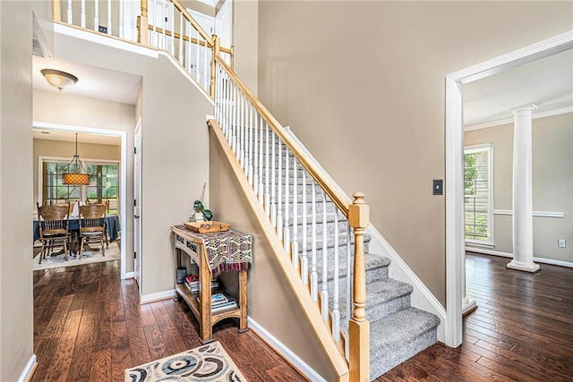 3117 Blowing Wind Ct NW, Acworth, GA 30101 - stairs with decorative columns, hardwood / wood-style flooring, and ornamental molding