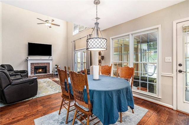 3117 Blowing Wind Ct NW, Acworth, GA 30101 - dining room featuring wood-type flooring, ceiling fan, and a brick fireplace