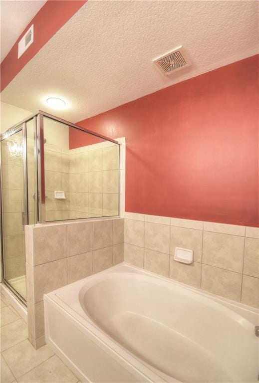 full bath featuring tile patterned floors, visible vents, a stall shower, and a garden tub