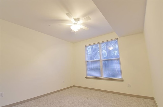 empty room featuring carpet flooring, a ceiling fan, and baseboards