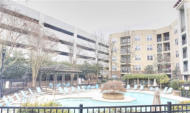 pool featuring a gazebo, a patio, and fence