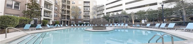 view of pool with a patio and fence