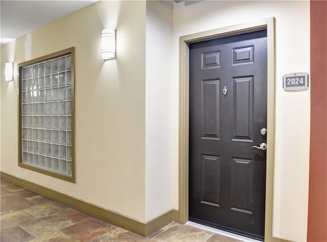 doorway to property featuring stucco siding