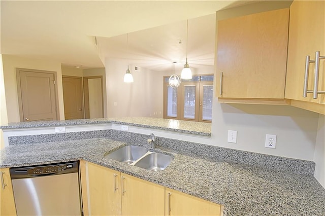 kitchen with light brown cabinetry, dishwasher, light stone counters, and a sink