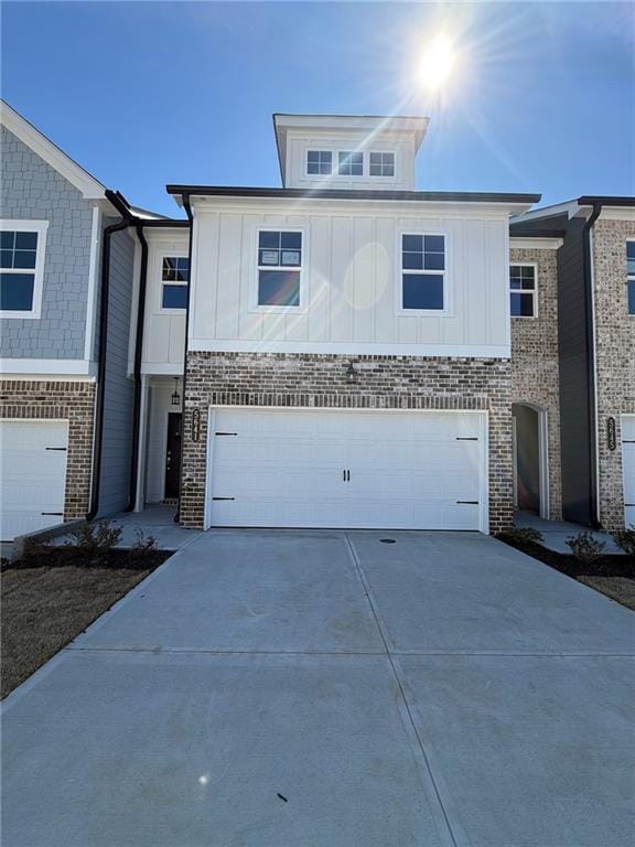 5641 Hislop Ln Unit 88, Mableton, GA 30126 - view of front of home with brick siding, driveway, board and batten siding, and a garage