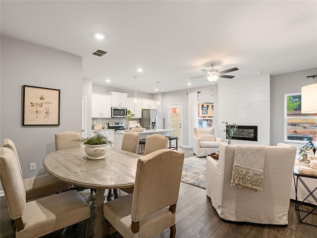 5641 Hislop Ln Unit 88, Mableton, GA 30126 - dining area featuring ceiling fan, a fireplace, dark wood finished floors, visible vents, and recessed lighting