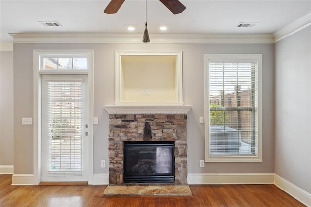 unfurnished living room featuring visible vents, wood finished floors, and a ceiling fan