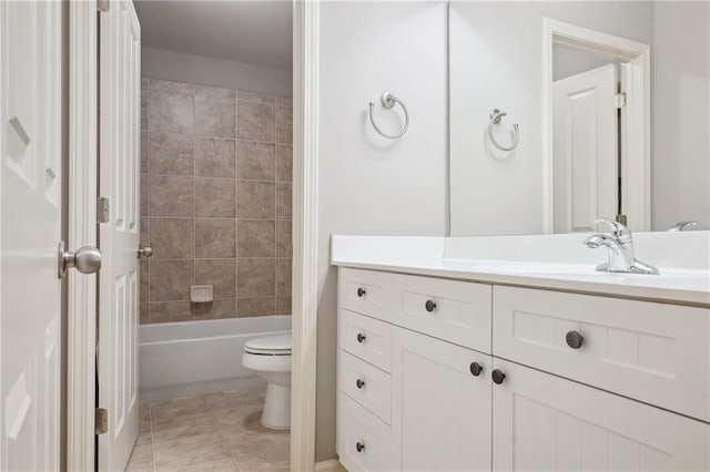 bathroom featuring tile patterned floors, toilet, vanity, and bathing tub / shower combination