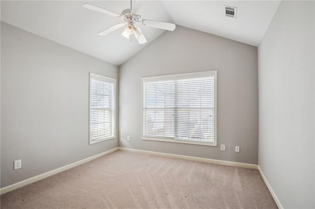 carpeted empty room with visible vents, baseboards, lofted ceiling, and a ceiling fan