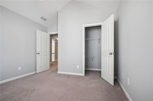 unfurnished bedroom featuring a closet, carpet flooring, visible vents, and baseboards