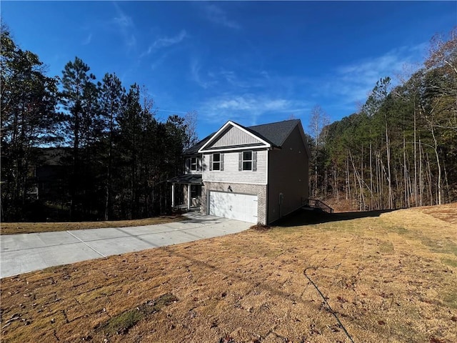 view of side of home with a lawn and a garage