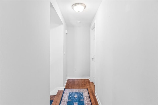 hall with wood finished floors and baseboards