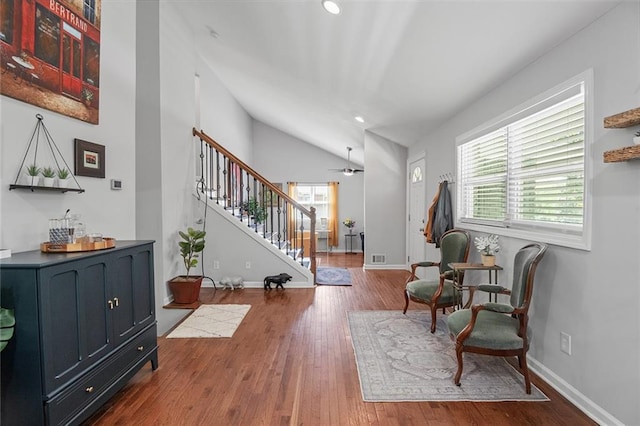 living area with stairway, vaulted ceiling, wood finished floors, and recessed lighting