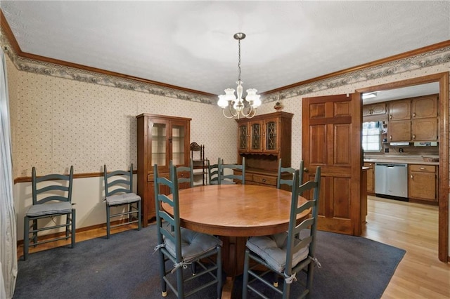 dining room featuring crown molding, a chandelier, and light wood-type flooring