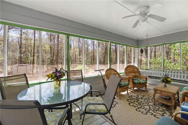 sunroom / solarium featuring ceiling fan