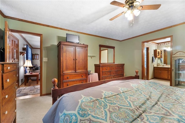 carpeted bedroom featuring crown molding, connected bathroom, ceiling fan, and a textured ceiling