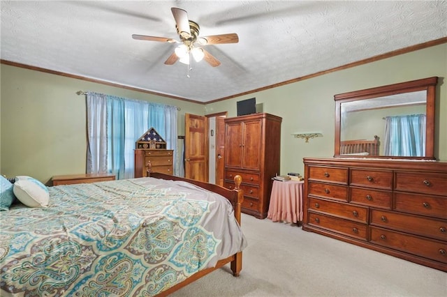 carpeted bedroom featuring ceiling fan, ornamental molding, and a textured ceiling