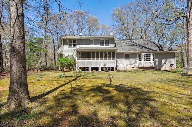 back of house with a sunroom and a lawn