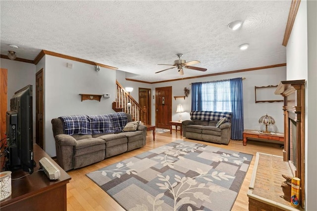 living room featuring ornamental molding, hardwood / wood-style floors, and ceiling fan