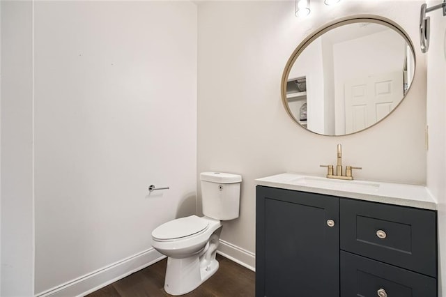 bathroom featuring hardwood / wood-style floors, vanity, and toilet