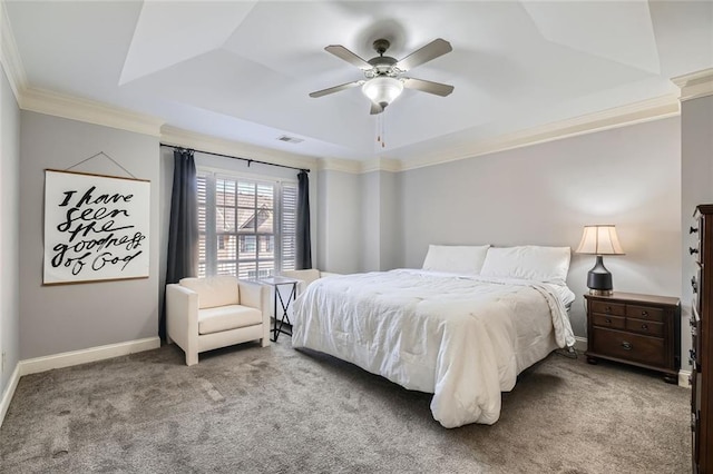 carpeted bedroom featuring a raised ceiling, ceiling fan, and crown molding