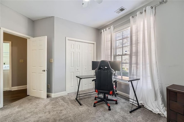 carpeted office with ceiling fan