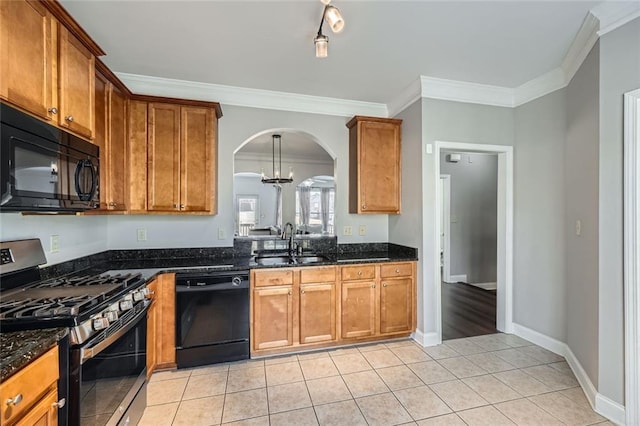 kitchen with dark stone counters, sink, black appliances, and ornamental molding