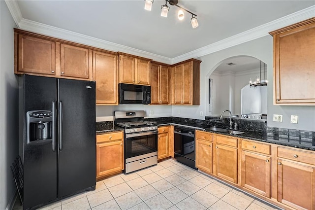 kitchen featuring dark stone counters, ornamental molding, sink, black appliances, and light tile patterned floors