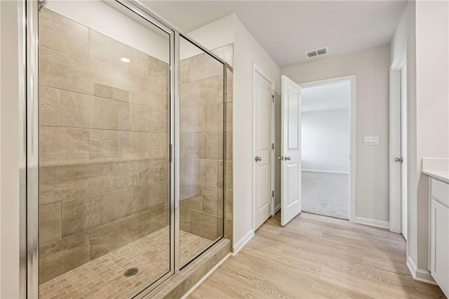 1539 High Falls Ln, Grayson, GA 30017 - bathroom with wood finished floors, a stall shower, and vanity