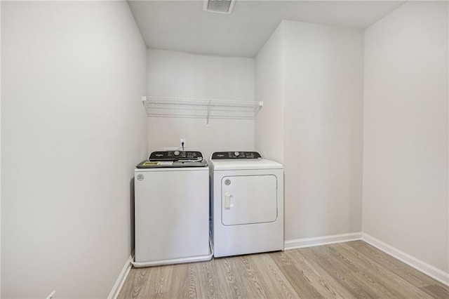 1539 High Falls Ln, Grayson, GA 30017 - laundry area featuring light wood-type flooring and separate washer and dryer