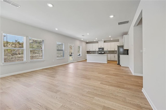 1539 High Falls Ln, Grayson, GA 30017 - unfurnished living room featuring light wood-type flooring and recessed lighting