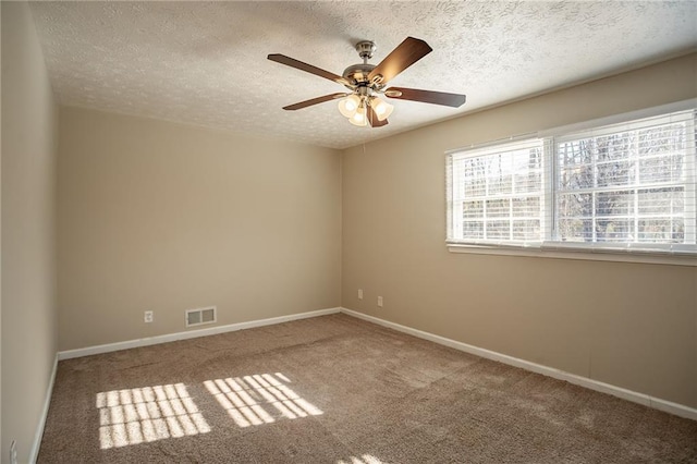 spare room with carpet flooring, a textured ceiling, and ceiling fan