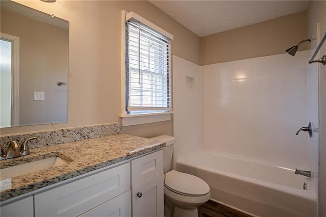 full bathroom with vanity, a healthy amount of sunlight, toilet, and washtub / shower combination