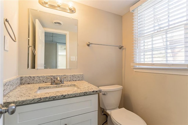 bathroom with vanity and toilet