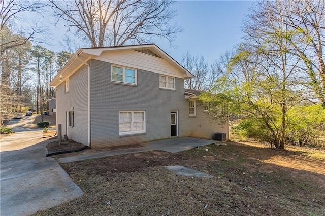 back of property with a patio area and central air condition unit