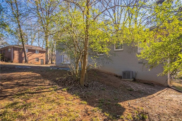 view of side of home with central air condition unit