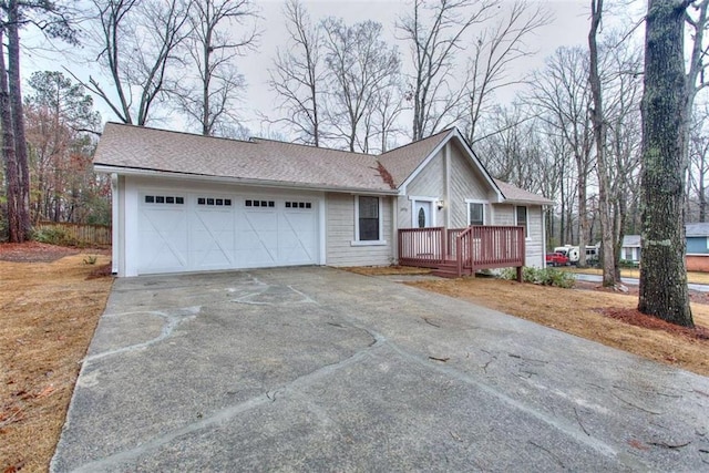 ranch-style home featuring a garage and a deck