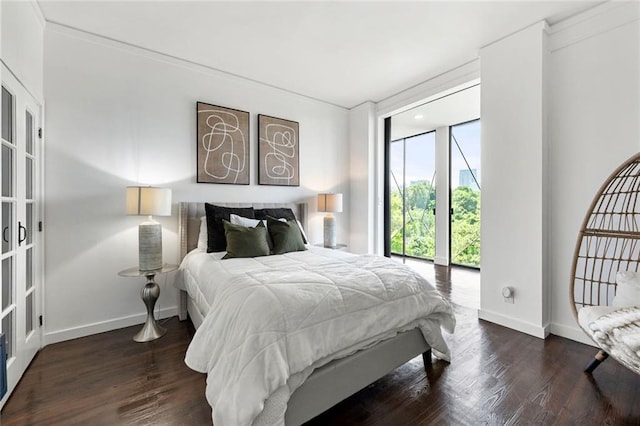 bedroom featuring wood finished floors and baseboards