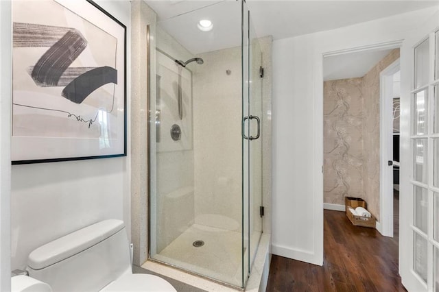 full bathroom featuring toilet, a shower stall, wood finished floors, and recessed lighting