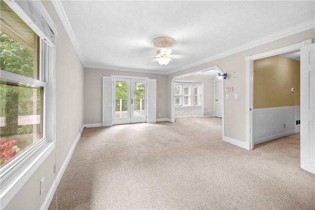 5065 Nesbit Ferry Ln, Atlanta, GA 30350 - unfurnished living room with a ceiling fan, crown molding, light colored carpet, a textured ceiling, and french doors