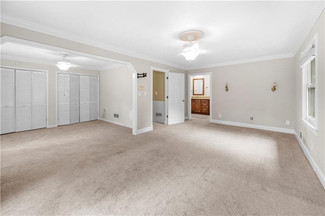 5065 Nesbit Ferry Ln, Atlanta, GA 30350 - unfurnished bedroom featuring multiple closets, light carpet, ornamental molding, and ensuite bath